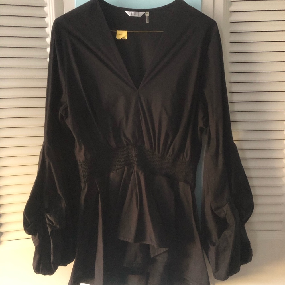 Pretty black balloon sleeve top with cascading ruffle on bottom.